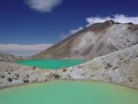 this is a picture of the emerald lakes that can be found when descending from the saddle between mount Tongariro and mount Ngauruhoe, the sight from up on the saddle looking towards mount Ruapehu in the back is unforgettable and truly one of the great sights that make a trip to New Zealand so worthwhile